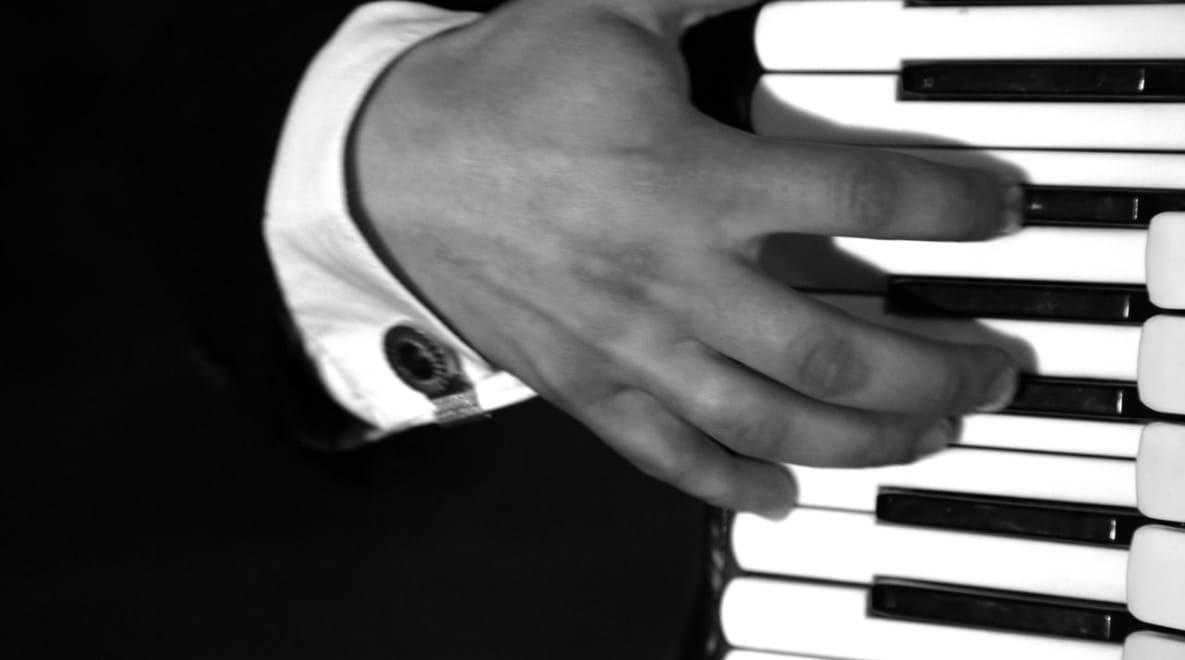 Devil’s hand touching accordion keys