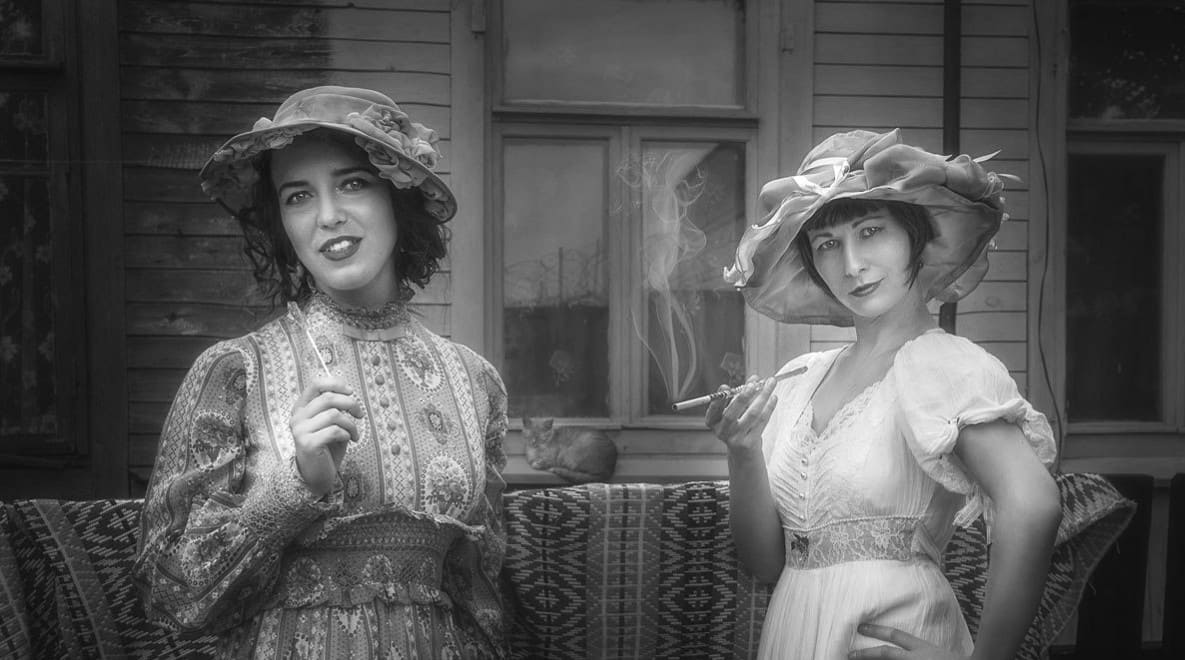 Girls – Etl & Tsetl – near that very ESTABLISHMENT of auntie Sofa, one smoking a cigarette, and another sucking sweets